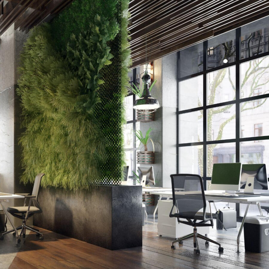 Image of office with desks, chairs and a wall of plants, big windows